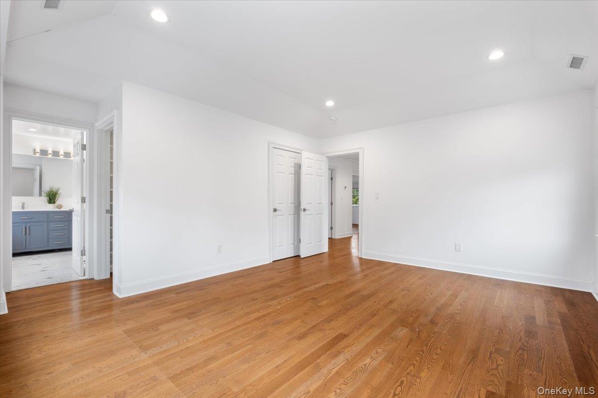 109 Lee Road Scarsdale, NY 10583 - Photo 11 of 30 a view of an empty room with wooden floor and a bathroom