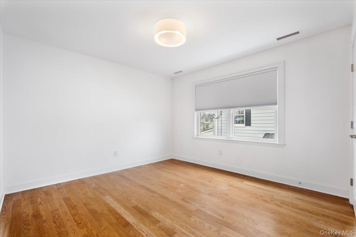 109 Lee Road Scarsdale, NY 10583 - Photo 15 of 30 a view of a big room with wooden floor and windows