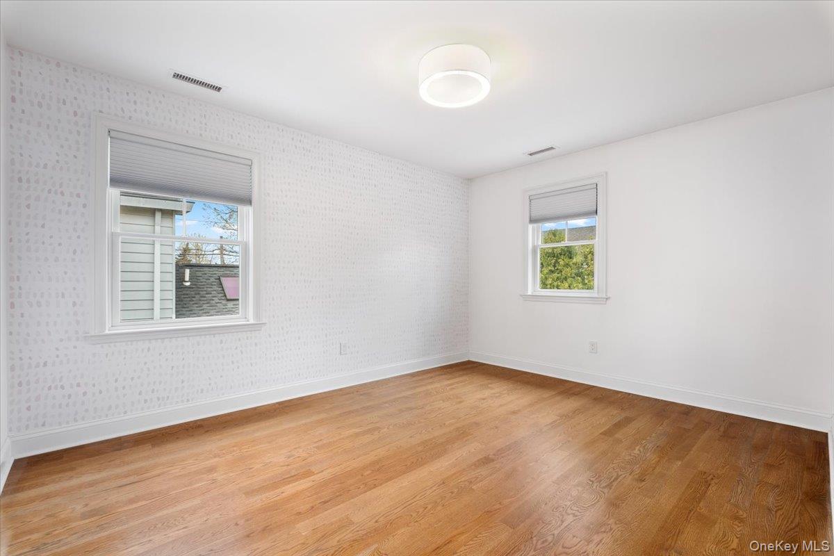 109 Lee Road Scarsdale, NY 10583 - Photo 17 of 30 a view of an empty room with a window and wooden floor