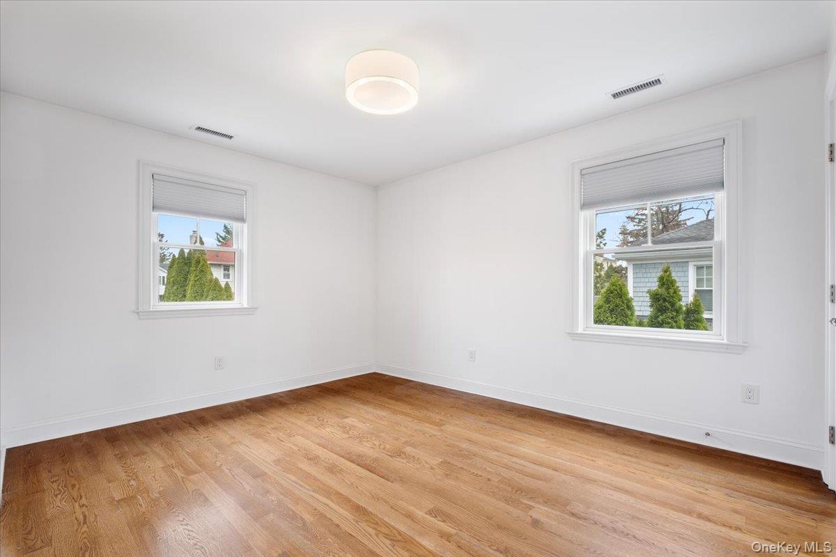 109 Lee Road Scarsdale, NY 10583 - Photo 19 of 30 a view of an empty room with wooden floor and a window
