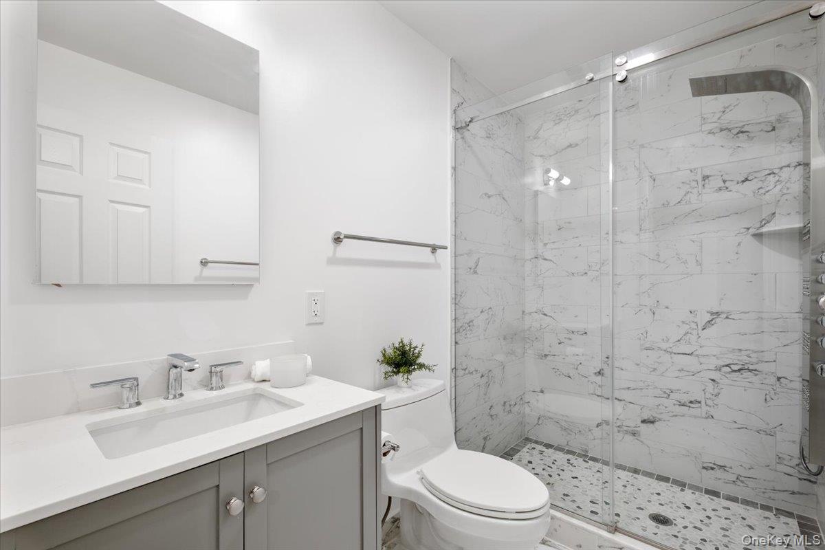 109 Lee Road Scarsdale, NY 10583 - Photo 20 of 30 a bathroom with a sink a toilet and shower