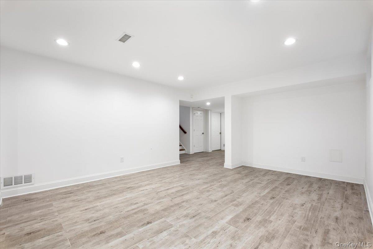 109 Lee Road Scarsdale, NY 10583 - Photo 23 of 30 an empty room with wooden floor and natural light
