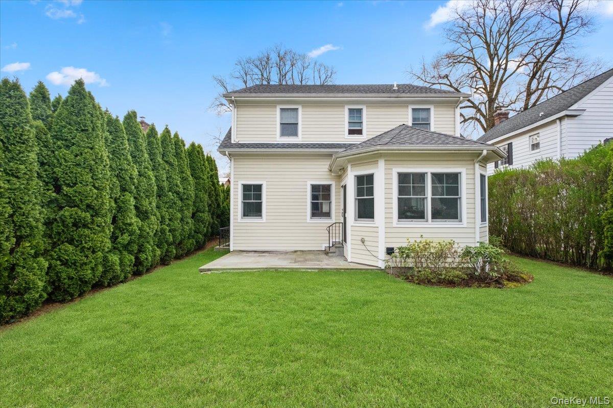 109 Lee Road Scarsdale, NY 10583 - Photo 26 of 30 a front view of a house with a garden