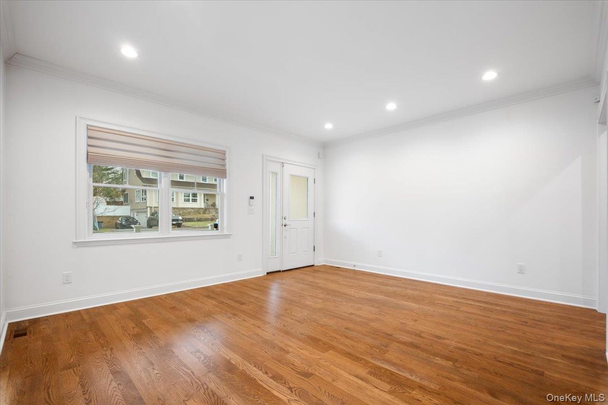 109 Lee Road Scarsdale, NY 10583 - Photo 3 of 30 a view of an empty room with wooden floor and a window