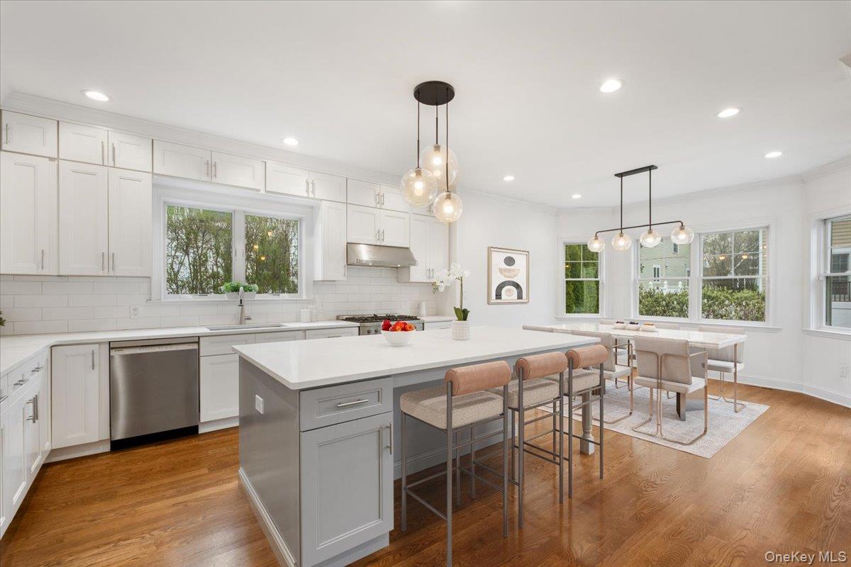 109 Lee Road Scarsdale, NY 10583 - Photo 4 of 30 a kitchen with a table chairs stove and cabinets