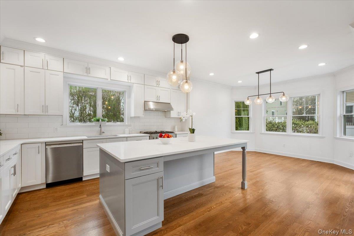 109 Lee Road Scarsdale, NY 10583 - Photo 5 of 30 a kitchen that has a lot of cabinets in it and wooden floors