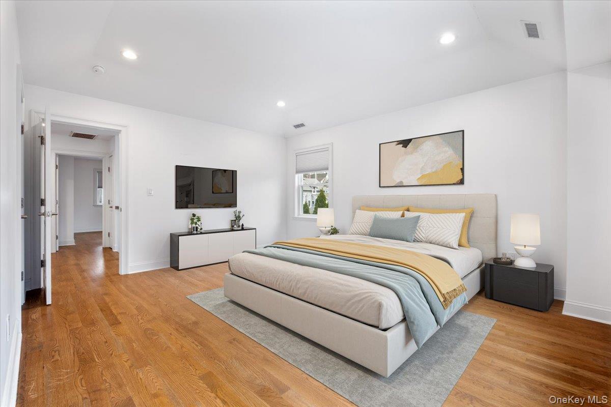 109 Lee Road Scarsdale, NY 10583 - Photo 10 of 30 a spacious bedroom with a bed and a flat screen tv