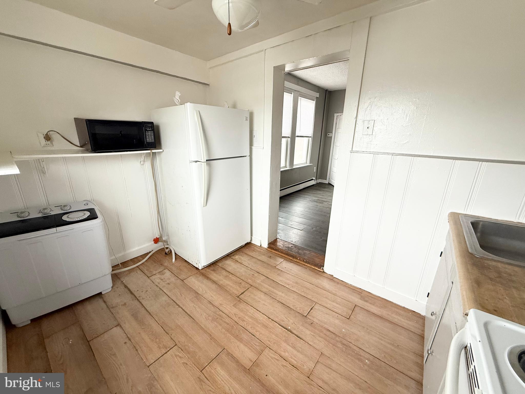 229 Ridley Avenue, Unit 1 Folsom, PA 19033 - Photo 5 of 13 a view of empty room with wooden floor and electronic appliances