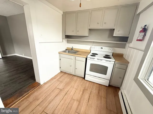 a kitchen with a stove top oven sink and cabinets