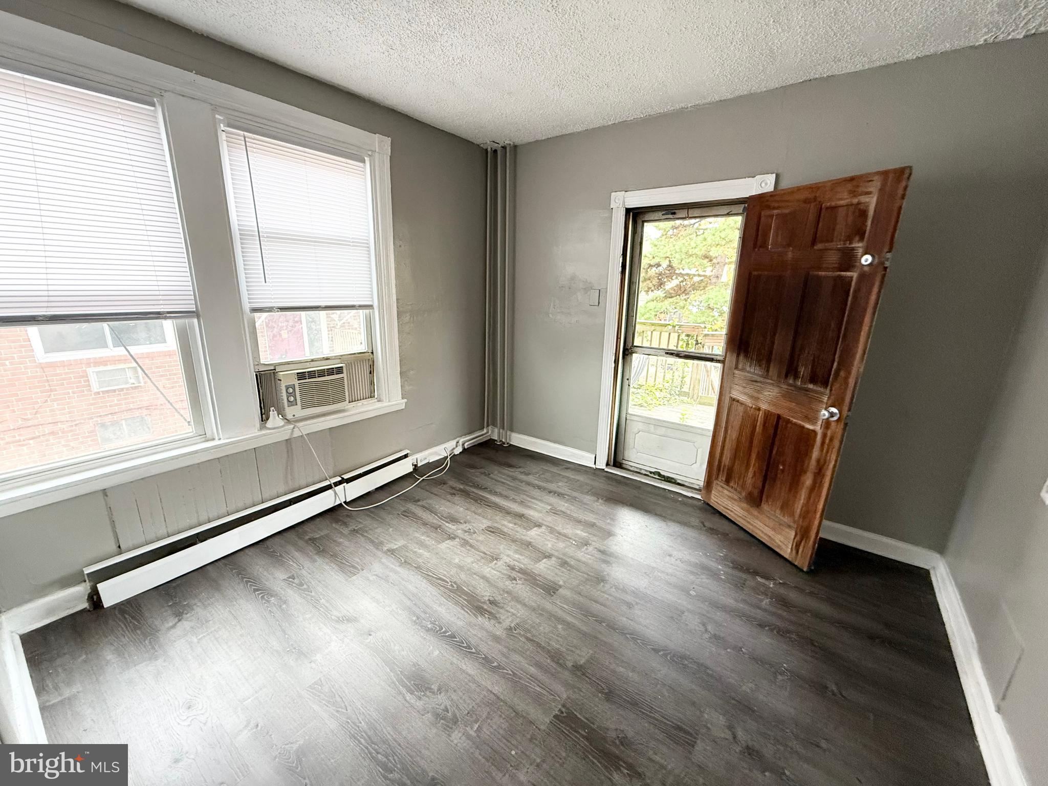 229 Ridley Avenue, Unit 1 Folsom, PA 19033 - Photo 9 of 13 a view of an empty room with wooden floor and a window