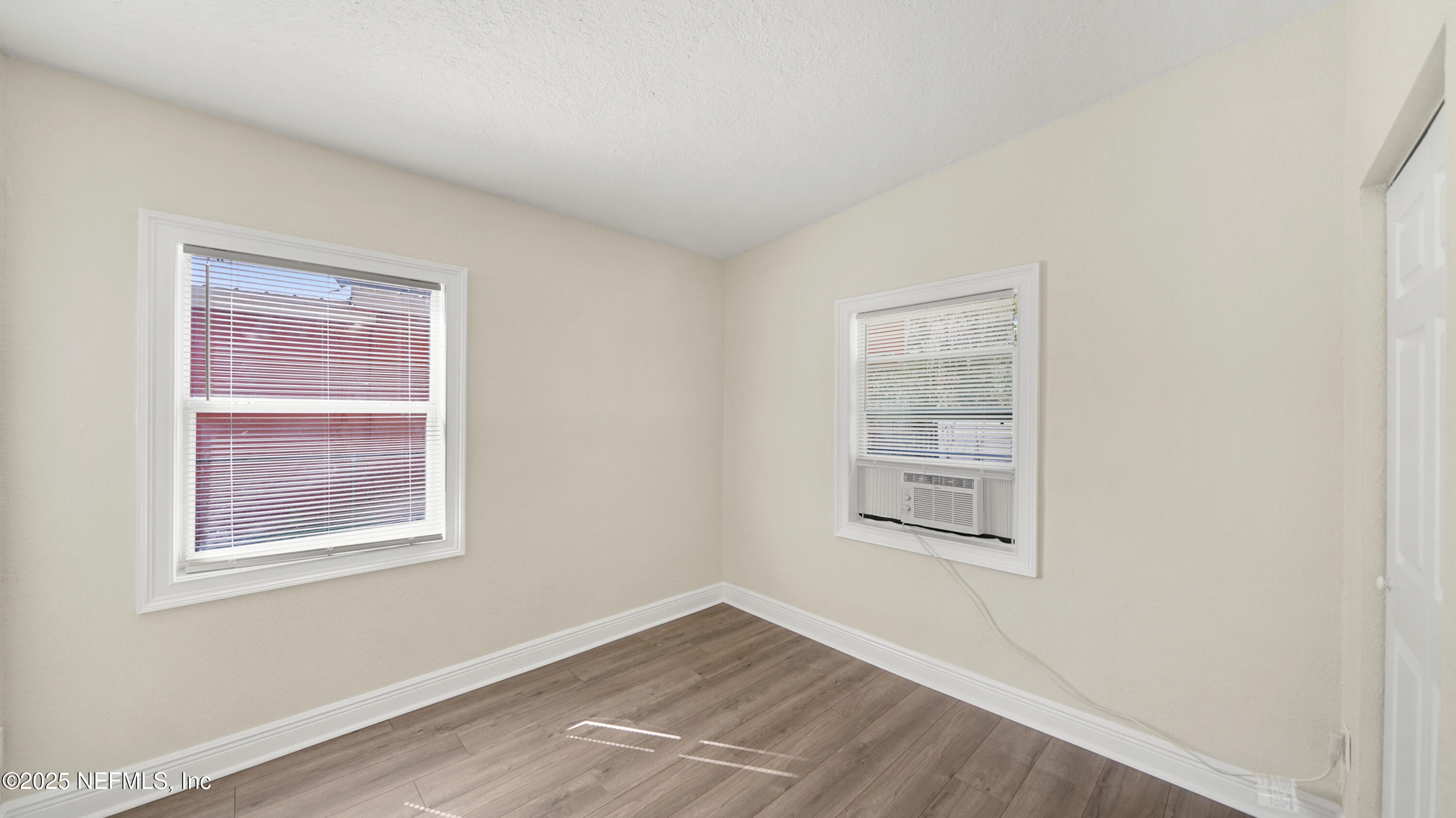 5524 Verbena Road Jacksonville, FL 32209 - Photo 13 of 17 a view of an empty room with a window and wooden floor
