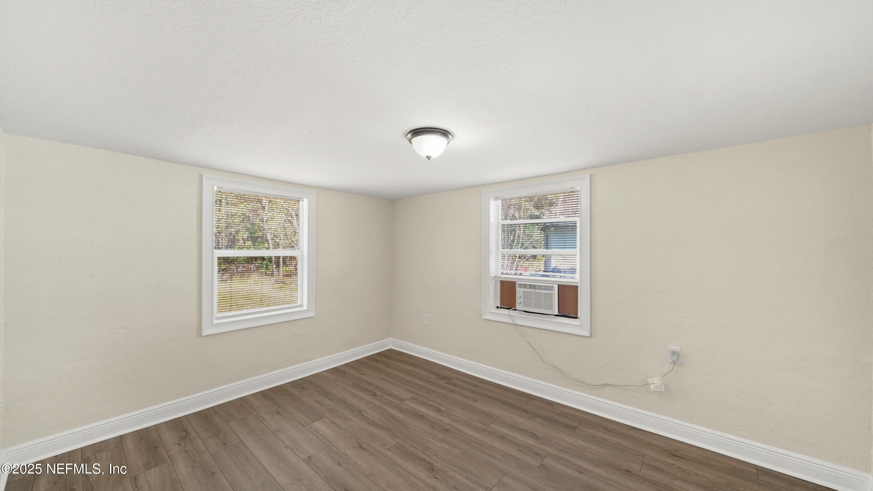 5524 Verbena Road Jacksonville, FL 32209 - Photo 7 of 17 a view of an empty room with wooden floor and a window