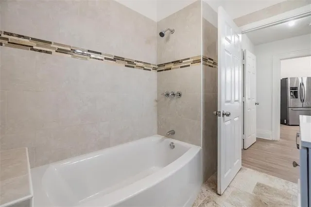 a bathroom with a bathtub a toilet and a shower