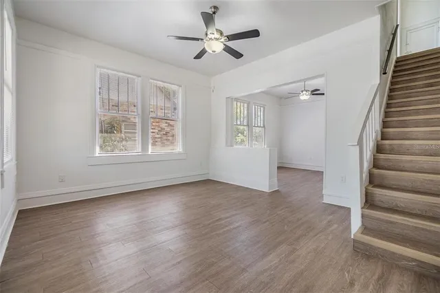 wooden floor in an empty room with a window