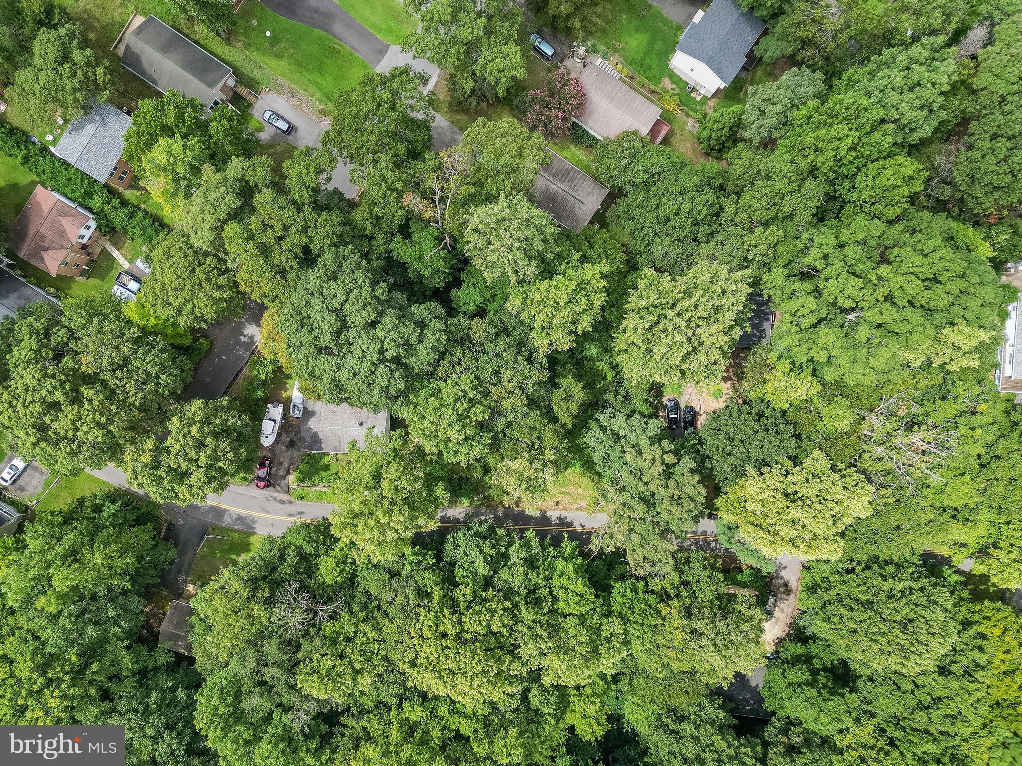8453 Pine Boulevard Lusby, MD 20657 - Photo 3 of 14 an aerial view of residential house with outdoor space and trees all around