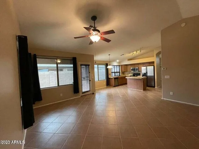 a view of a livingroom with furniture and a ceiling fan