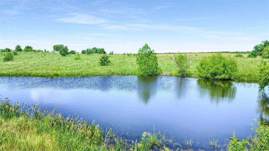 105 A Spalding Road Whitesboro, TX 76273 - Photo 2 of 30 a view of a lake with a garden
