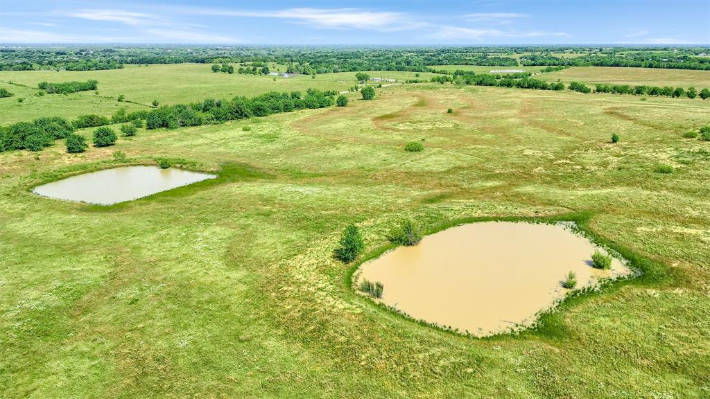 105 A Spalding Road Whitesboro, TX 76273 - Photo 26 of 30 a view of a swimming pool with a yard and lake view