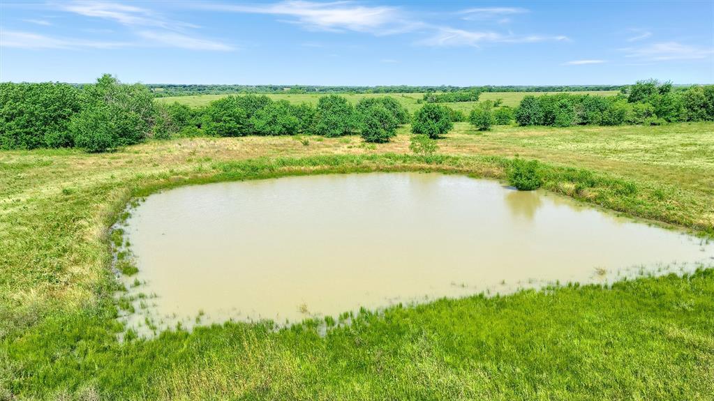 105 A Spalding Road Whitesboro, TX 76273 - Photo 28 of 30 a view of a lake with a yard