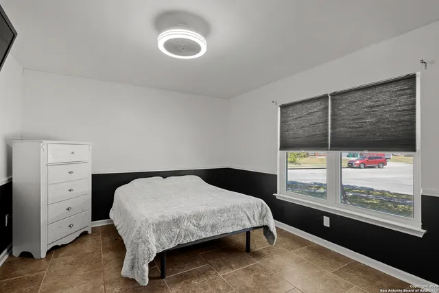 a bedroom with a bed and window