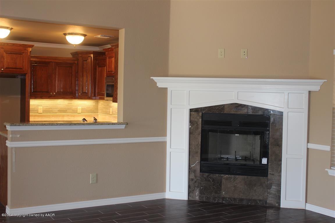 3910 Arden Road Amarillo, TX 79118 - Photo 3 of 15 a living room with a fireplace and a window