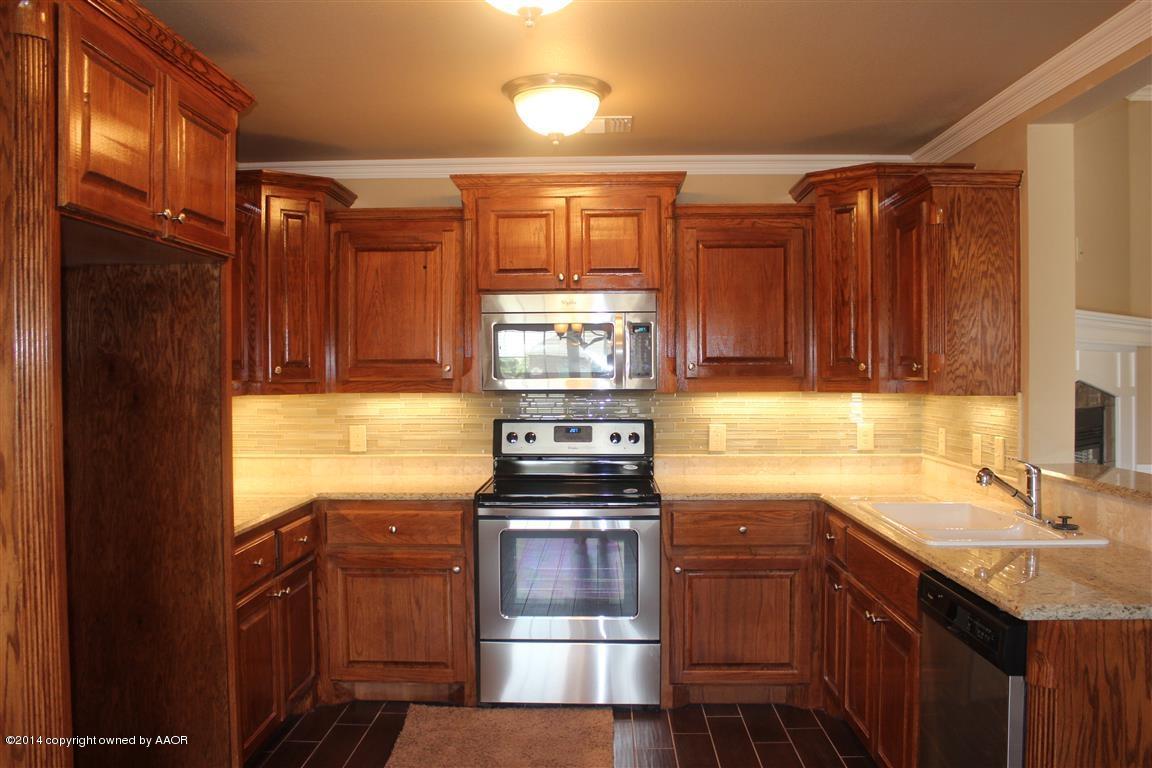 3910 Arden Road Amarillo, TX 79118 - Photo 7 of 15 a kitchen with stainless steel appliances granite countertop a stove and a sink