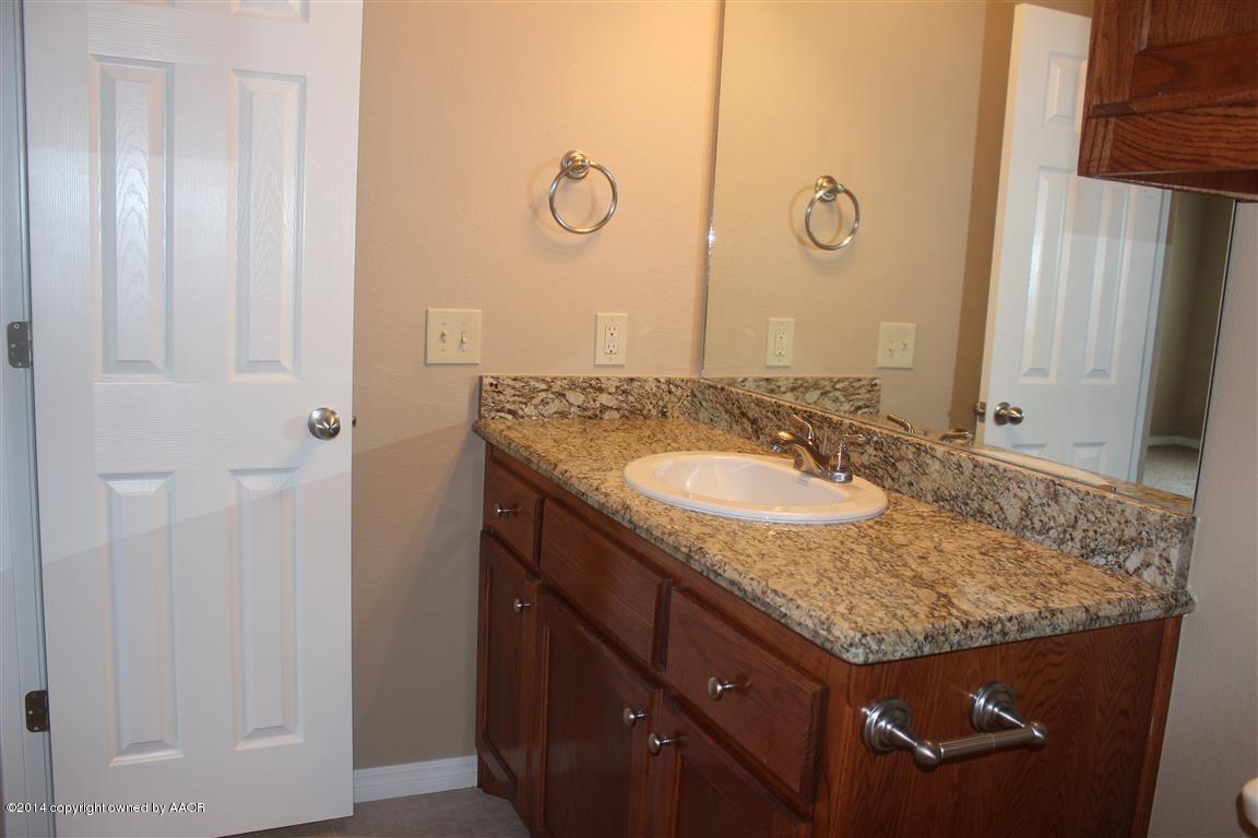 3910 Arden Road Amarillo, TX 79118 - Photo 10 of 15 a bathroom with a granite countertop sink and a mirror