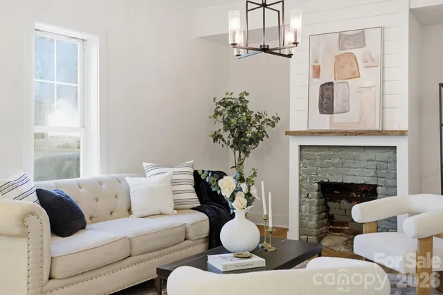 a spacious bedroom with a bed a couch and a potted plant