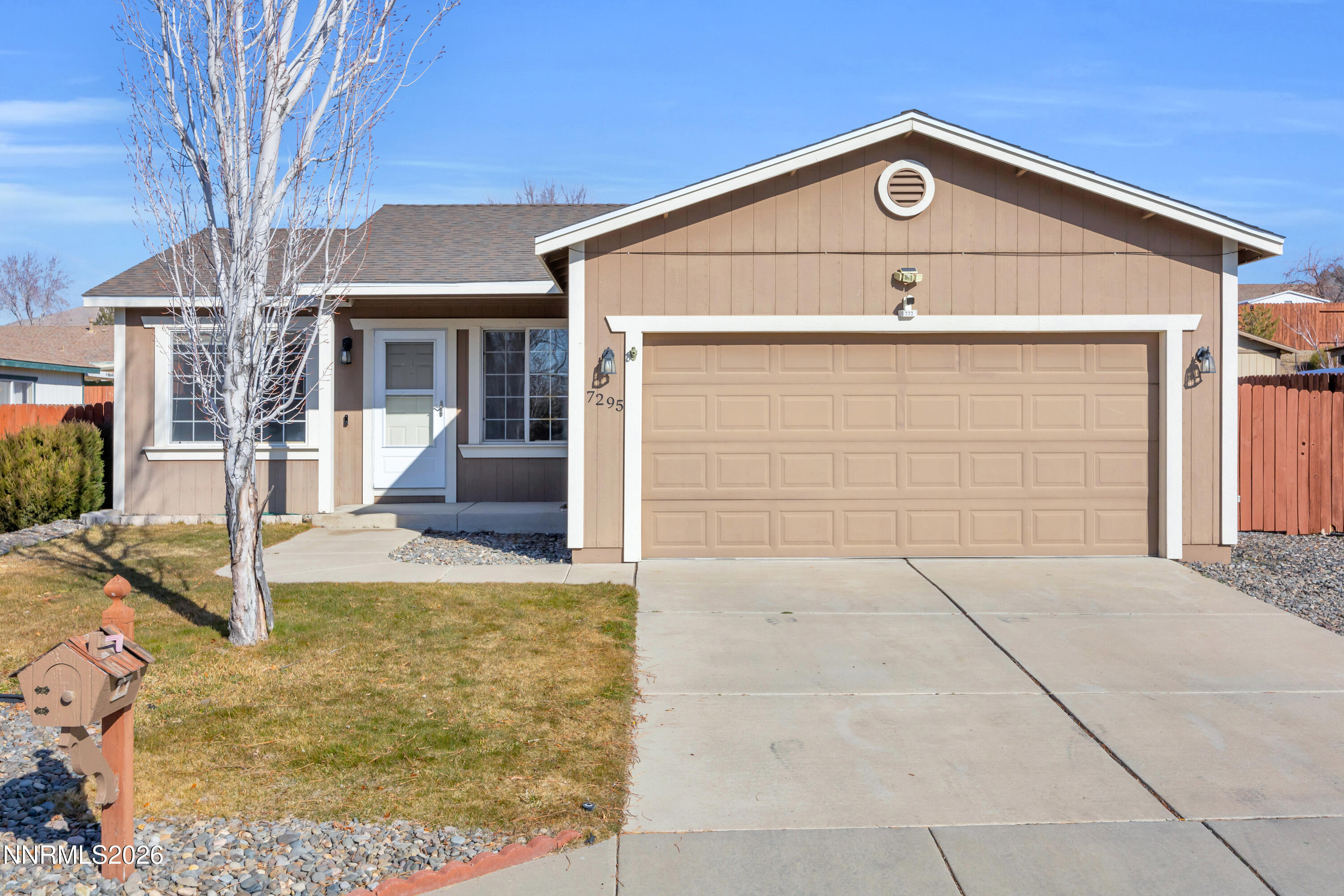 7295 Raphael Drive Sun Valley, NV 89433 - Photo 15 of 44 a front view of a house with garden