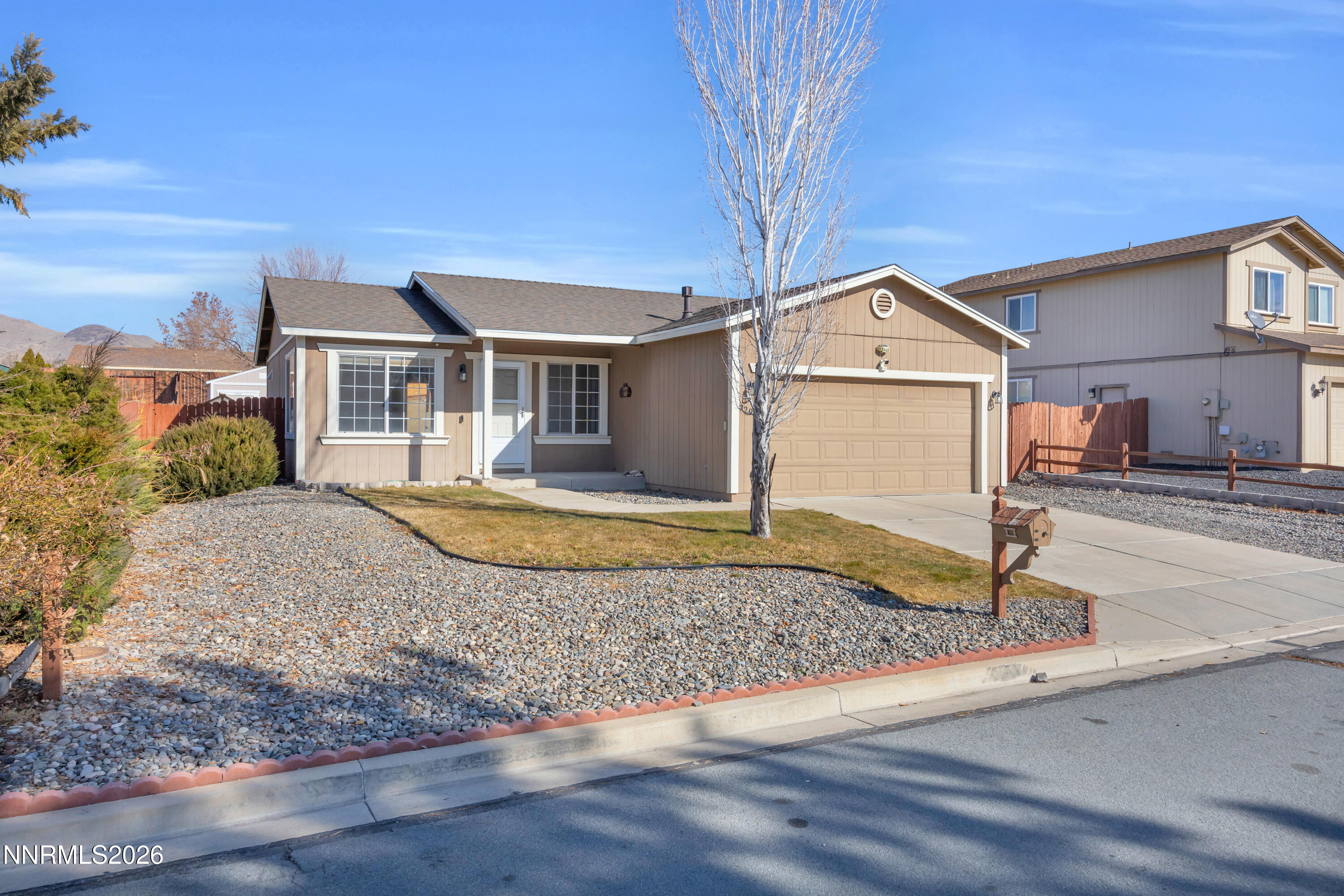 7295 Raphael Drive Sun Valley, NV 89433 - Photo 16 of 44 a front view of a house with garden