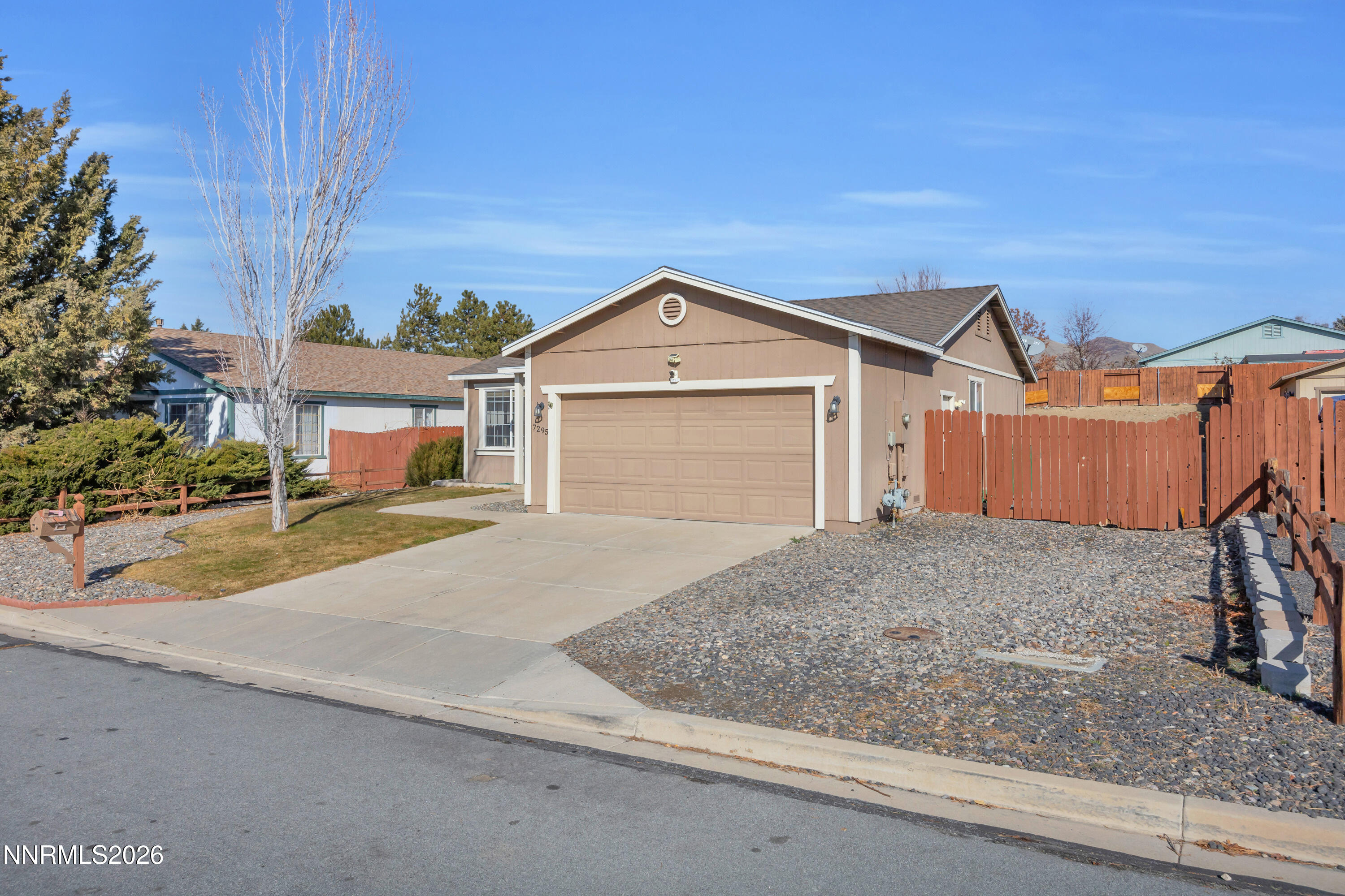 7295 Raphael Drive Sun Valley, NV 89433 - Photo 17 of 44 a front view of a house with a yard and garage
