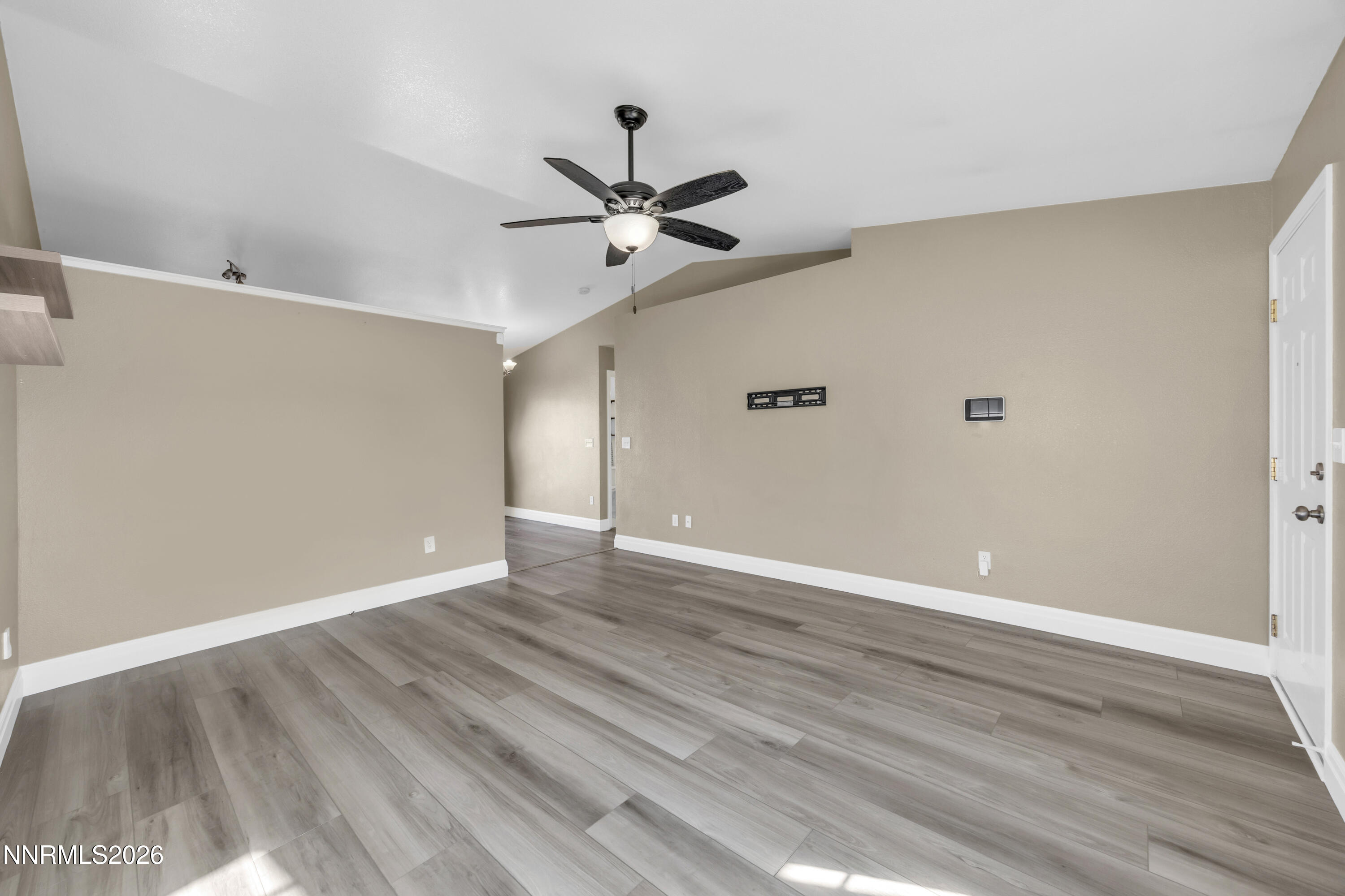 7295 Raphael Drive Sun Valley, NV 89433 - Photo 20 of 44 a view of an empty room with wooden floor