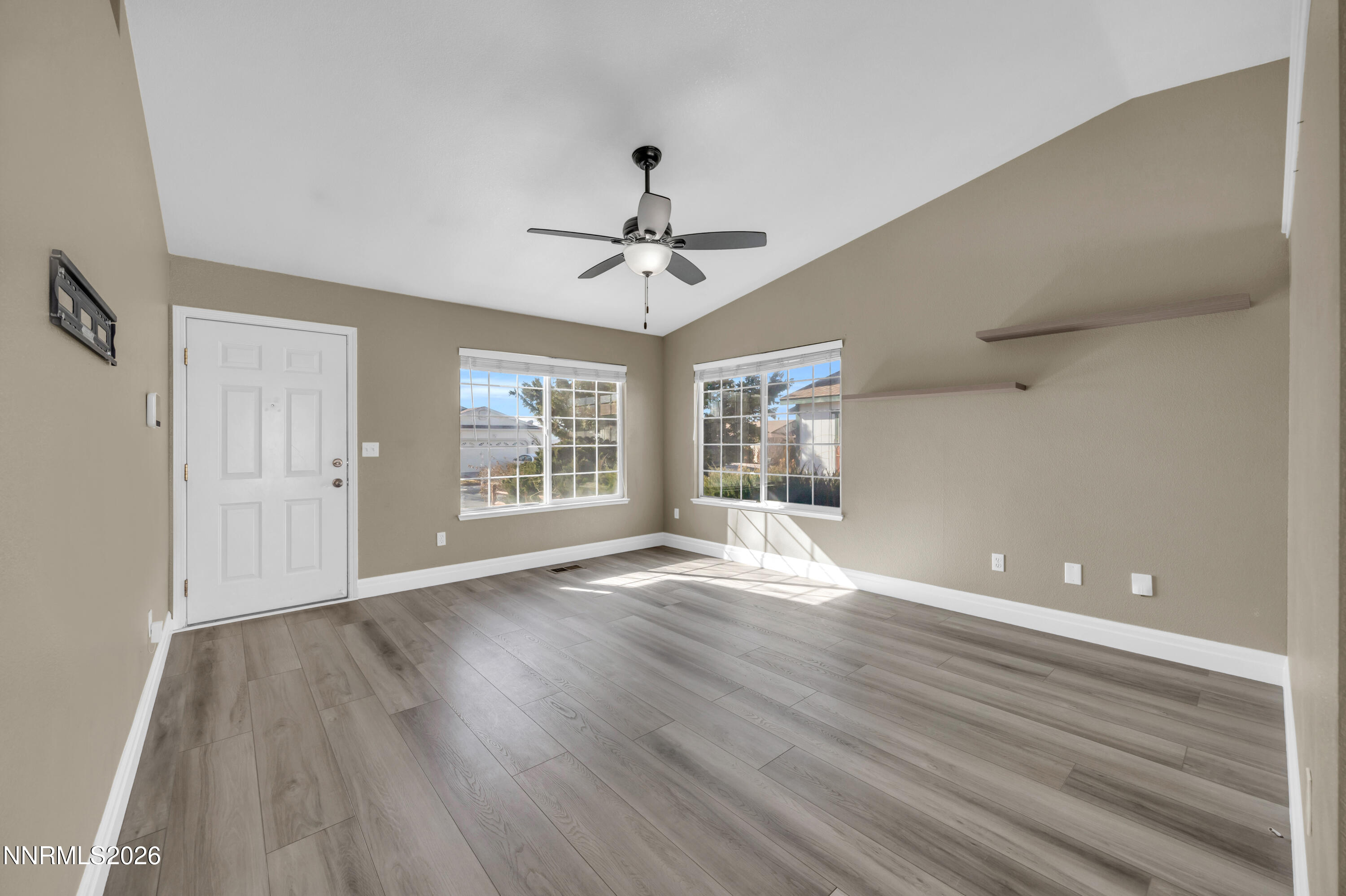 7295 Raphael Drive Sun Valley, NV 89433 - Photo 21 of 44 a view of an empty room with wooden floor and a window