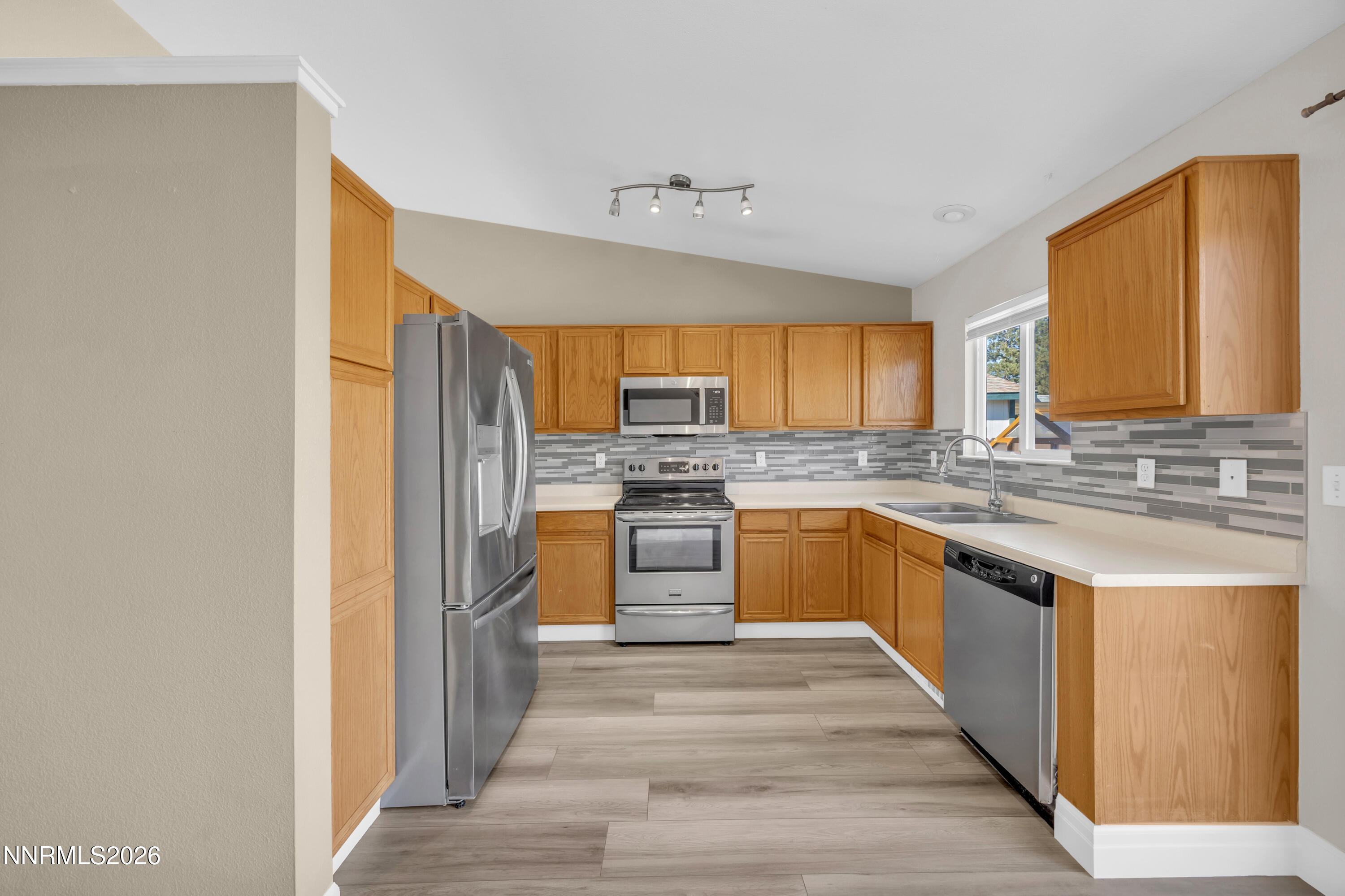 7295 Raphael Drive Sun Valley, NV 89433 - Photo 25 of 44 a kitchen with stainless steel appliances granite countertop a refrigerator and a stove top oven