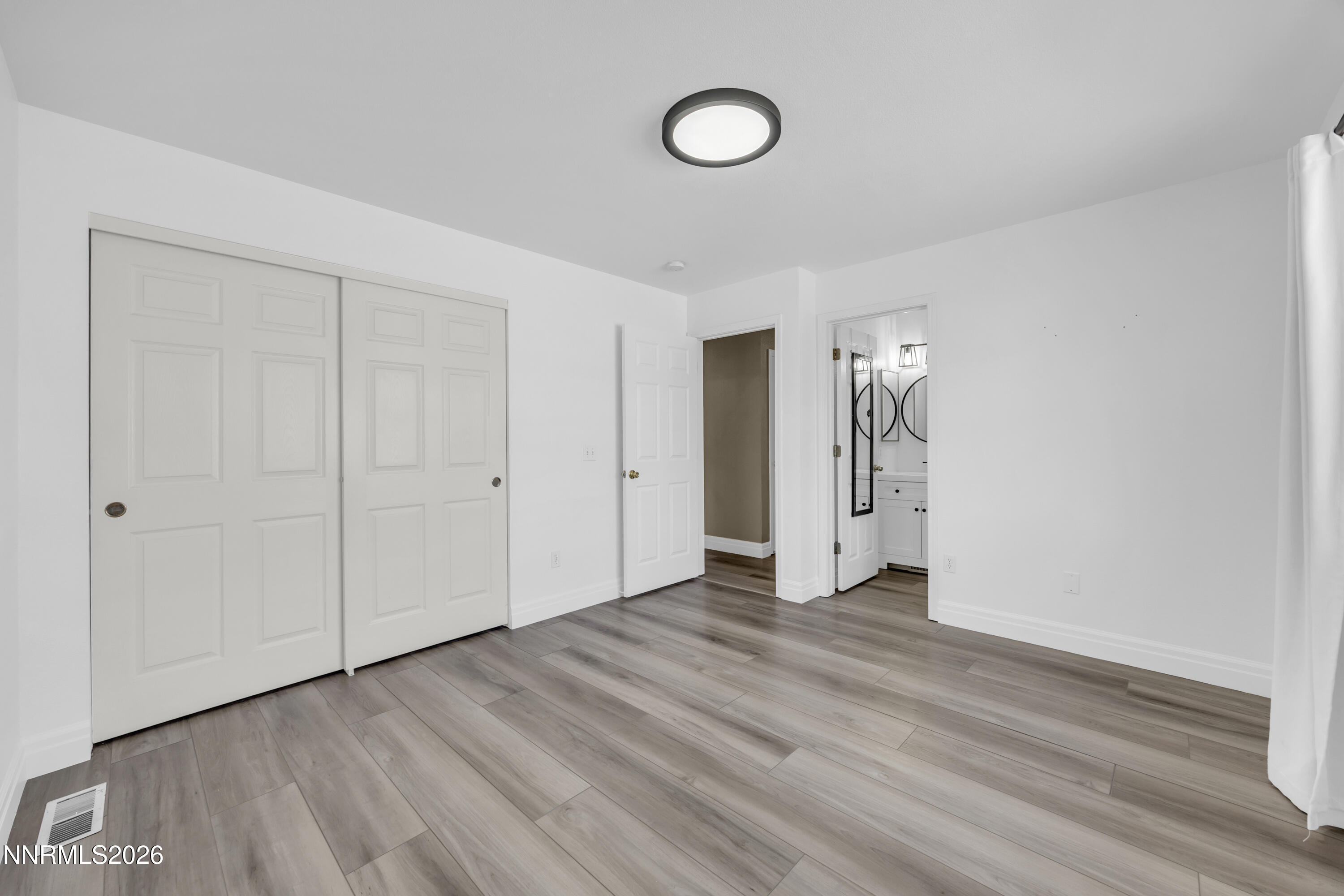 7295 Raphael Drive Sun Valley, NV 89433 - Photo 30 of 44 a view of an empty room with wooden floor