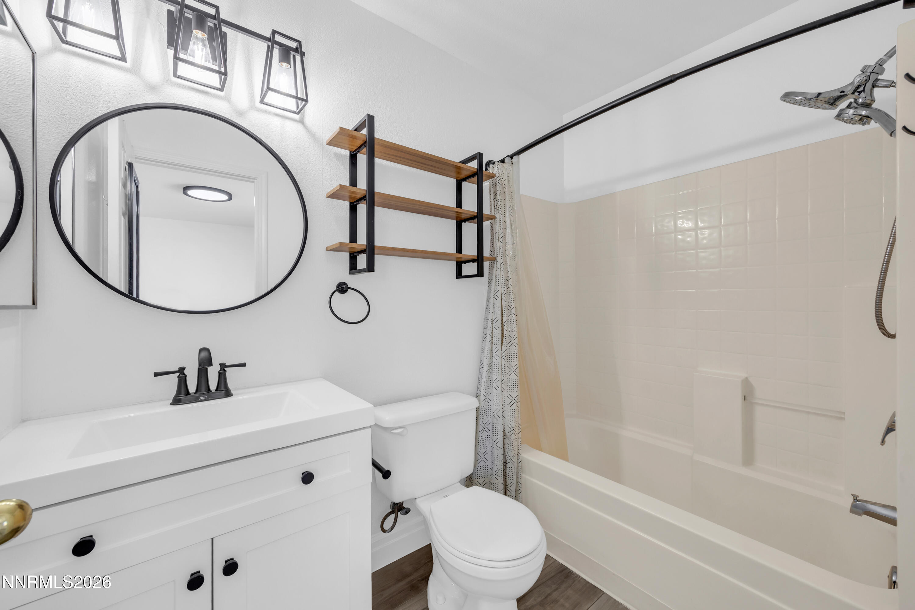 7295 Raphael Drive Sun Valley, NV 89433 - Photo 31 of 44 a bathroom with a toilet sink vanity tub and shower