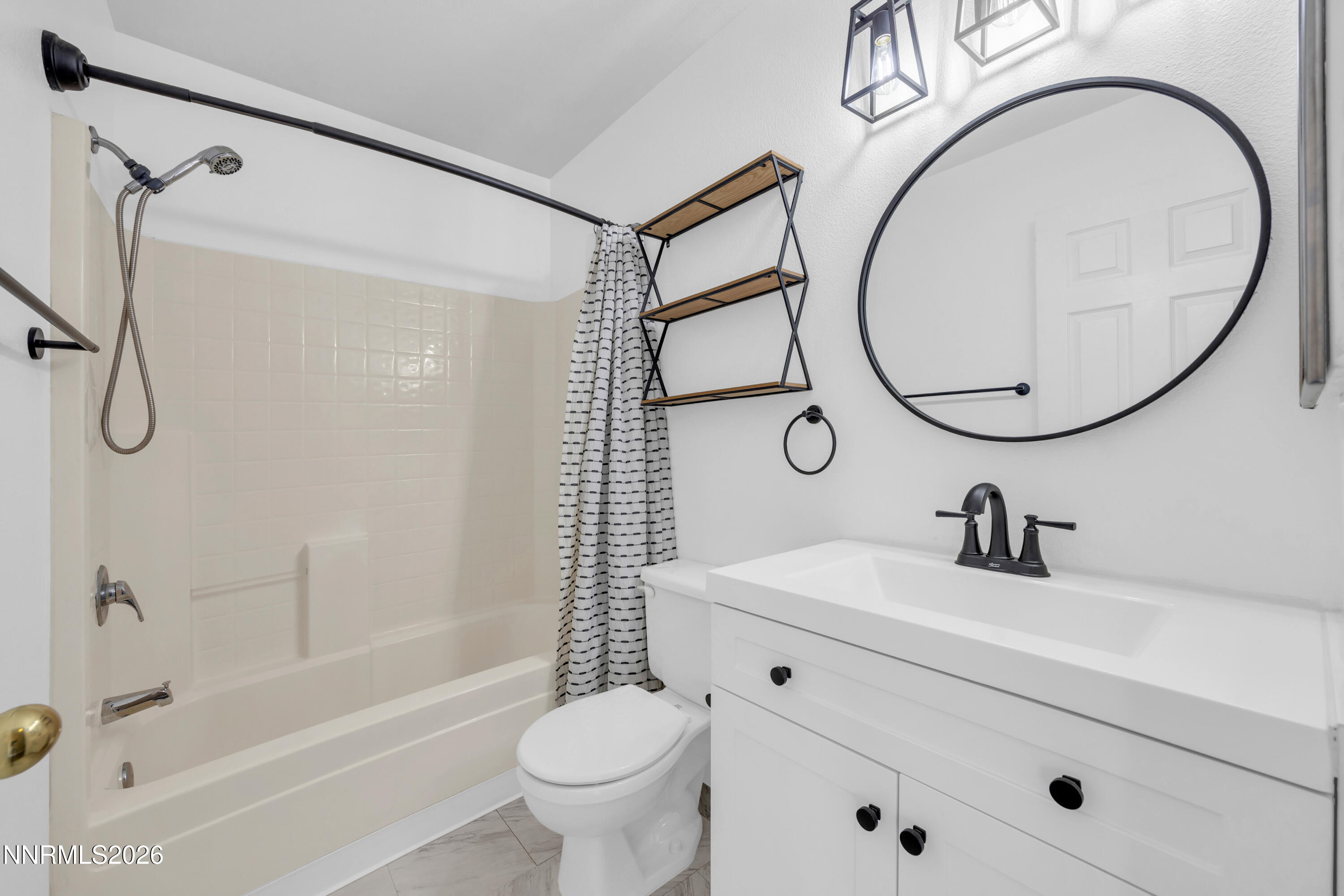 7295 Raphael Drive Sun Valley, NV 89433 - Photo 35 of 44 a bathroom with a sink a toilet and a mirror