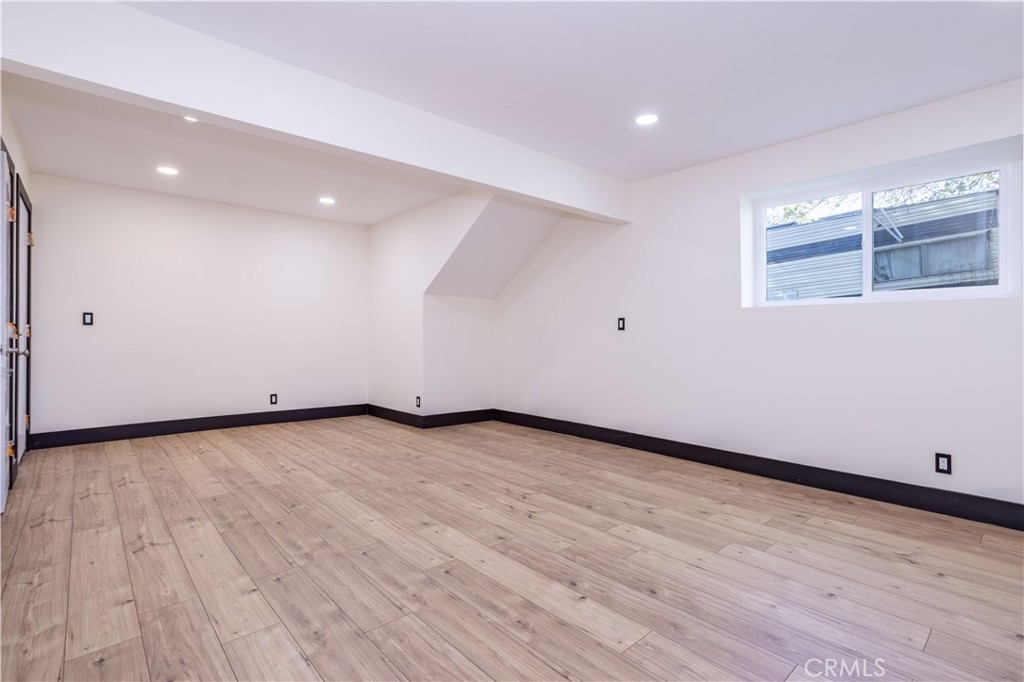 42640 Ranch Club Road Lake Hughes, CA 93532 - Photo 16 of 27 an empty room with wooden floor and windows