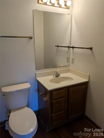 a bathroom with a sink mirror vanity and toilet