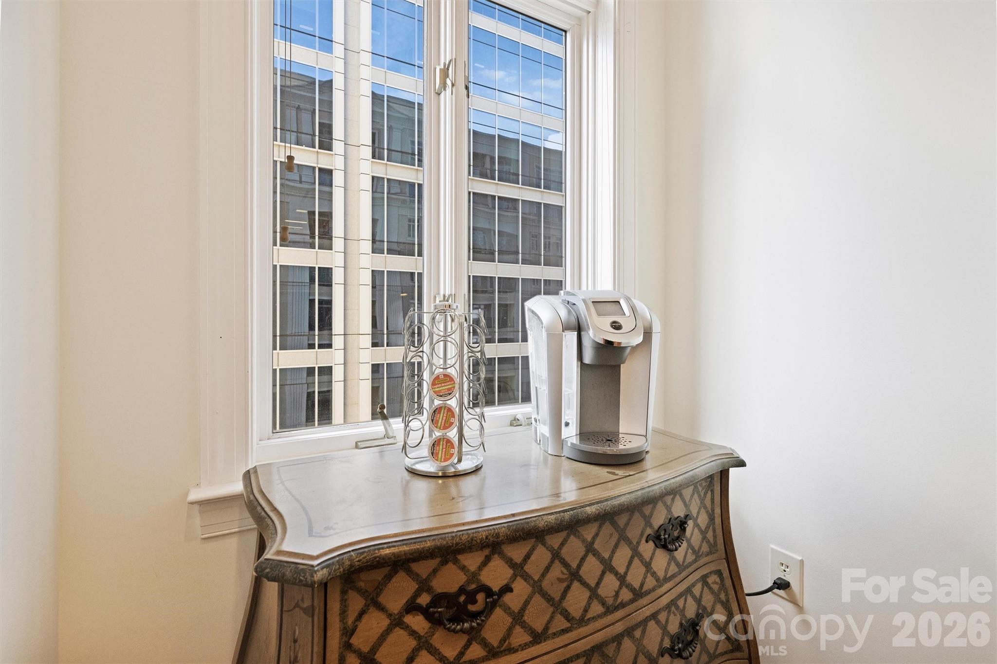 230 South Tryon Street, Unit 908 Charlotte, NC 28281 - Photo 14 of 31 a view of a dining room with a table and chairs
