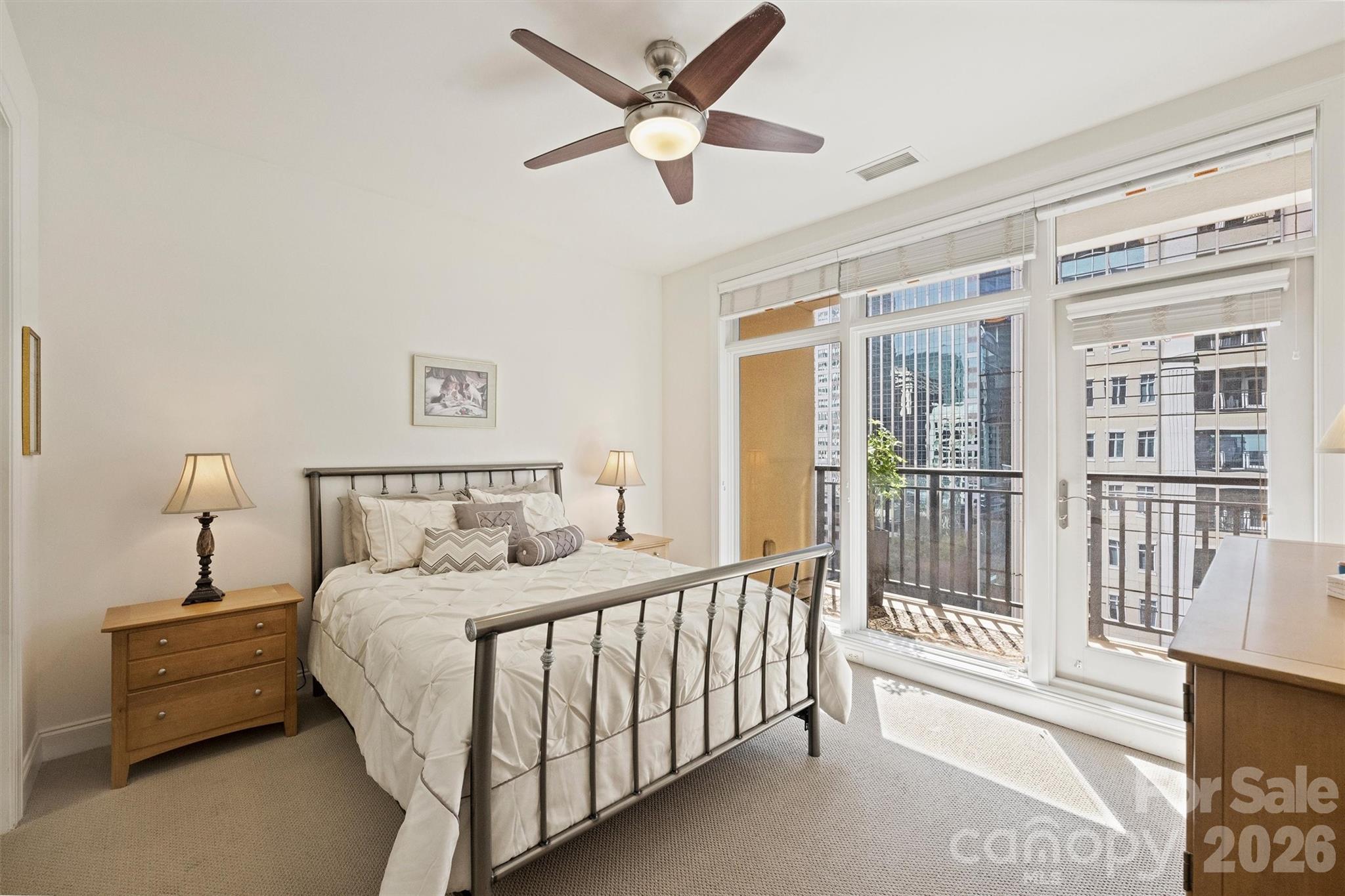 230 South Tryon Street, Unit 908 Charlotte, NC 28281 - Photo 20 of 31 a bedroom with a bed and a large window