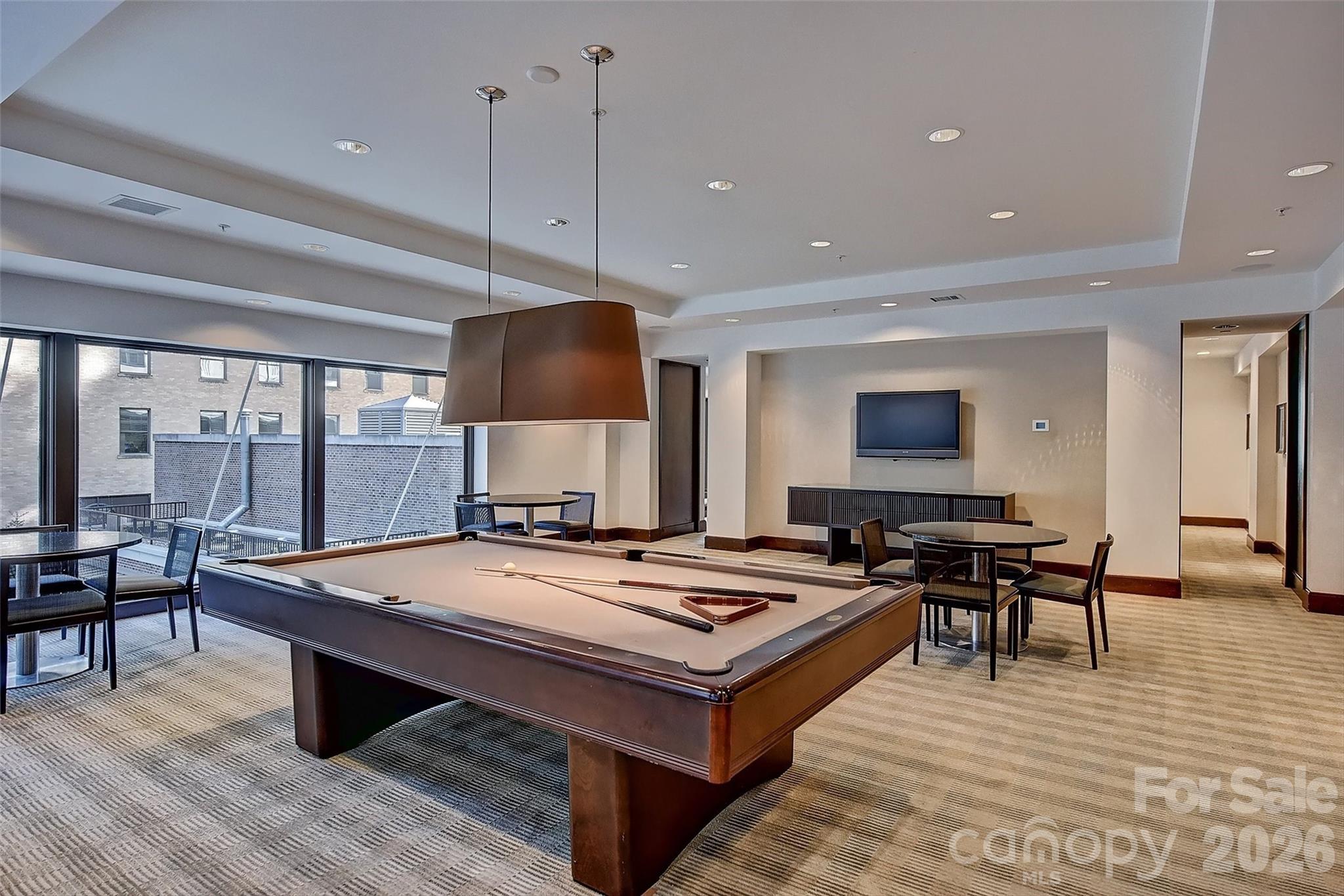 230 South Tryon Street, Unit 908 Charlotte, NC 28281 - Photo 25 of 31 a living room with furniture a table and chairs