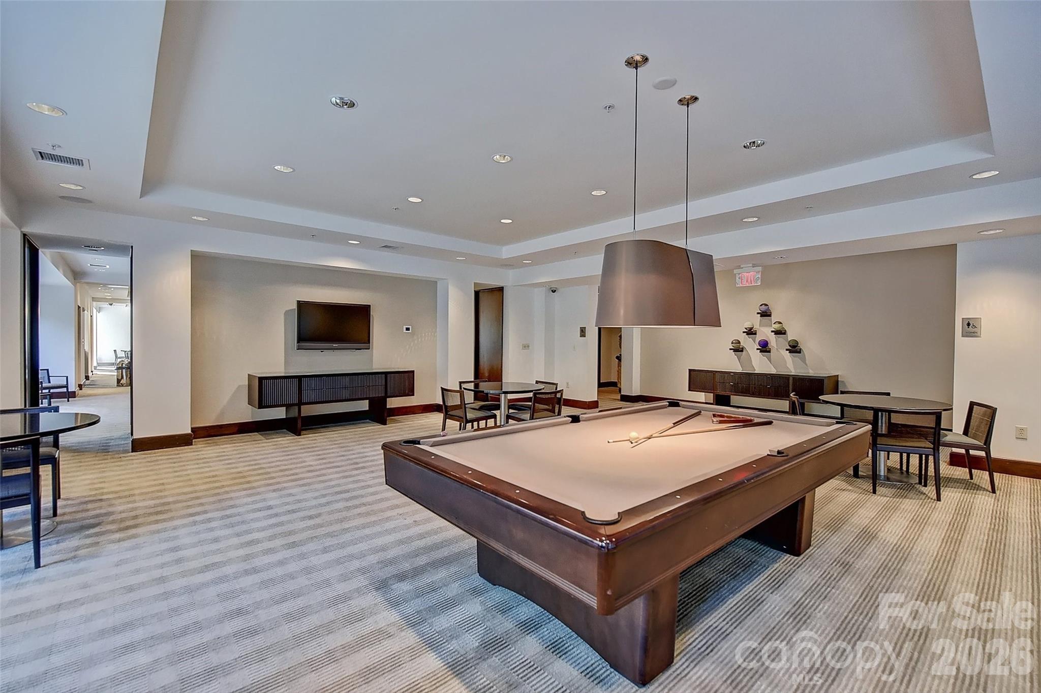 230 South Tryon Street, Unit 908 Charlotte, NC 28281 - Photo 26 of 31 a living room with furniture a table and wooden floor
