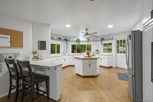 a large kitchen with a table and chairs