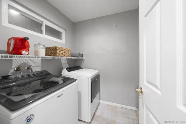 a utility room with sink dryer and washer