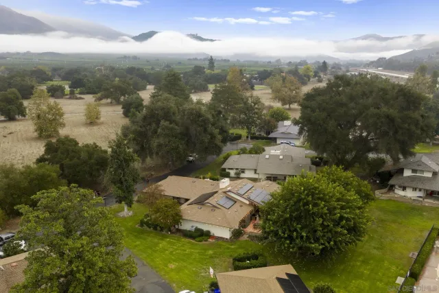 an aerial view of residential house with parking space and mountain view