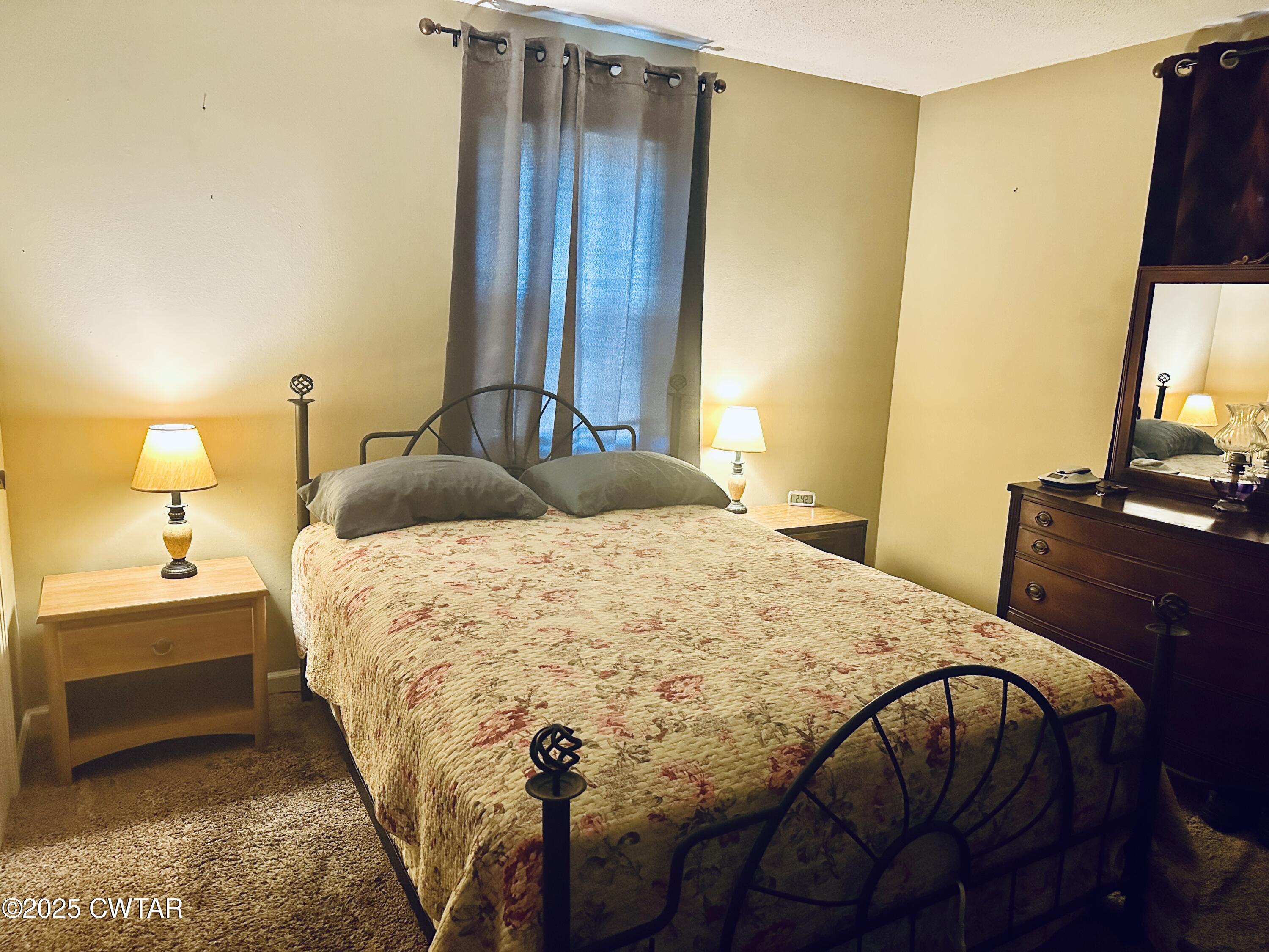 112 Fox Street Rutherford, TN 38369 - Photo 12 of 14 a bedroom with a bed and a flat tv screen on dresser