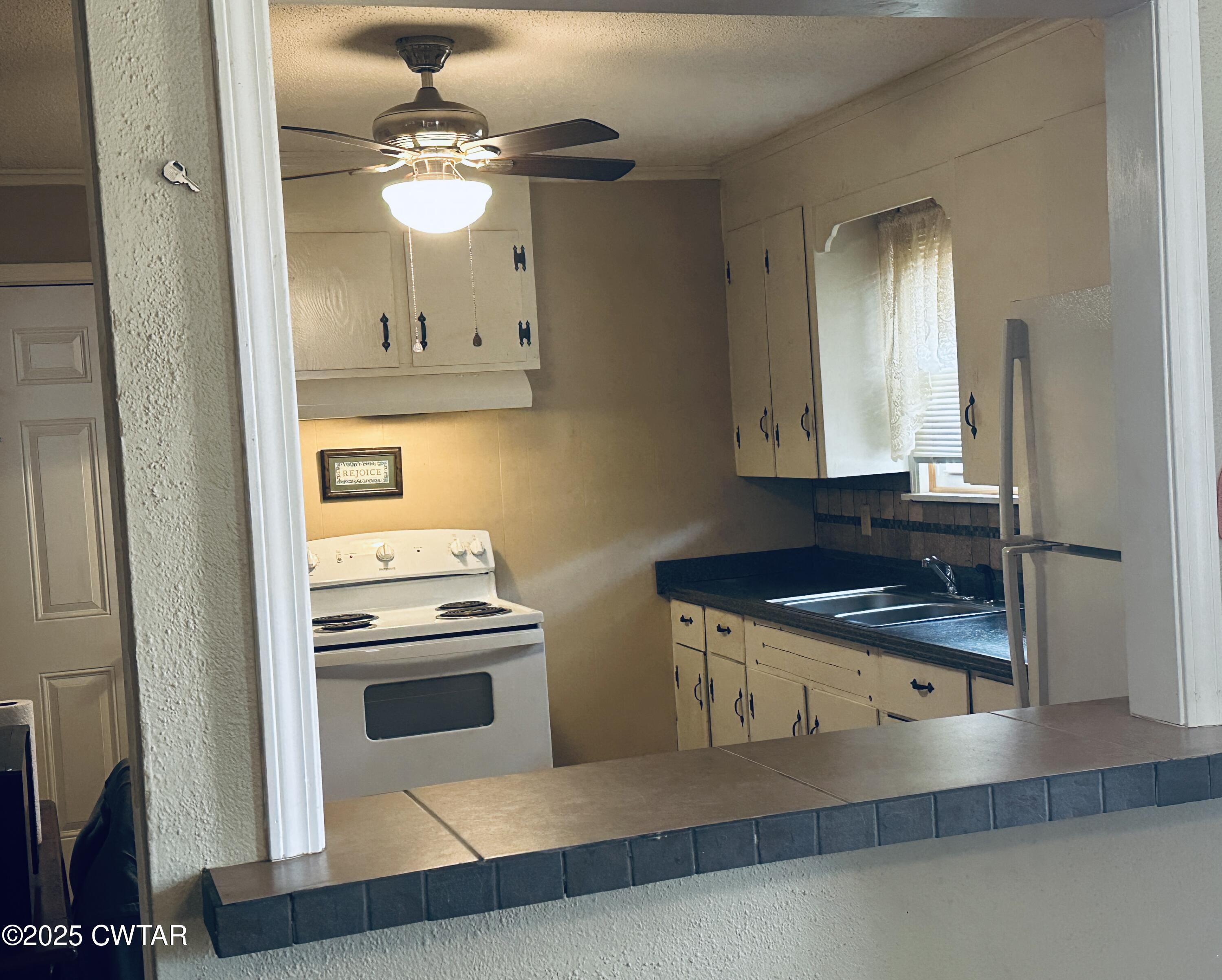112 Fox Street Rutherford, TN 38369 - Photo 9 of 14 a kitchen with stainless steel appliances granite countertop a sink a stove and a refrigerator