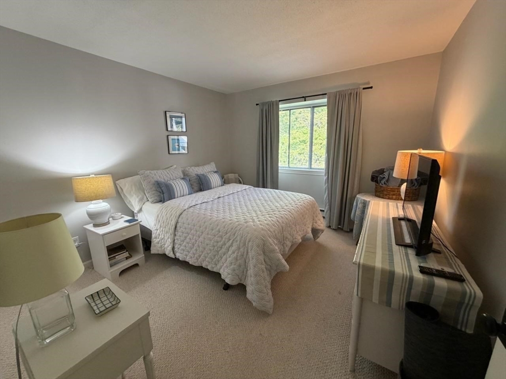 150 Eaton Lane, Unit 150 Brewster, MA 02631 - Photo 14 of 20 a bed room with a bed and a window