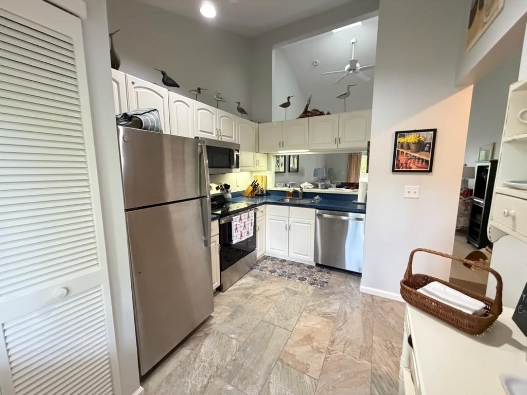 150 Eaton Lane, Unit 150 Brewster, MA 02631 - Photo 7 of 20 a kitchen with stainless steel appliances granite countertop a refrigerator and a sink